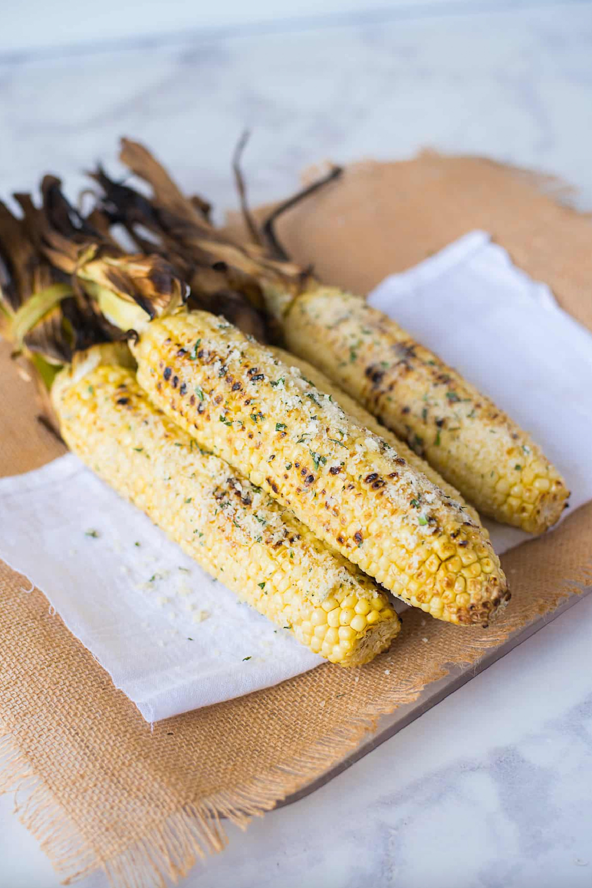 stacked grilled parmesan garlic and basil corn on the cob