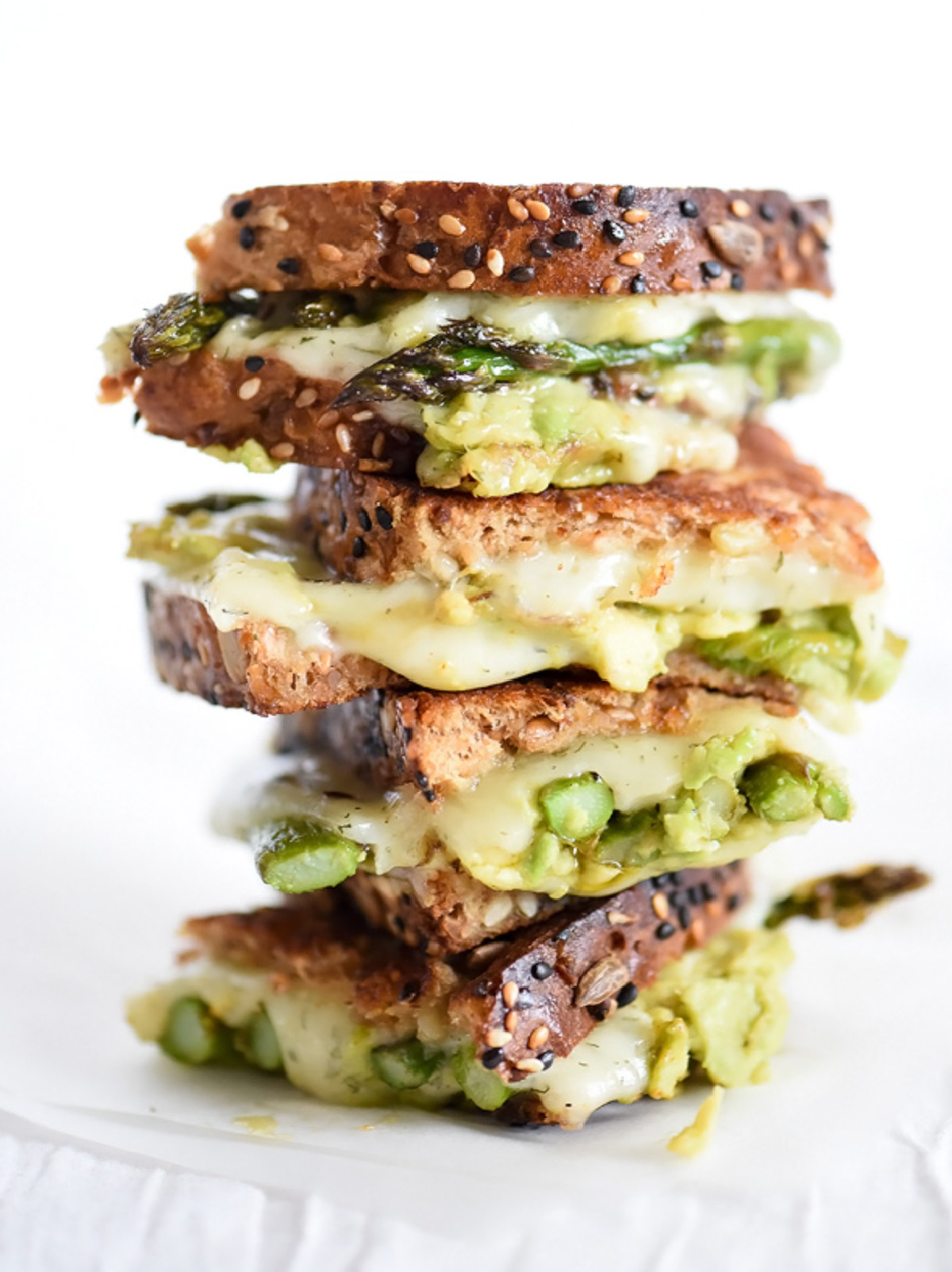 stacked spicy smashed avocado asparagus with dill havarti grilled cheese