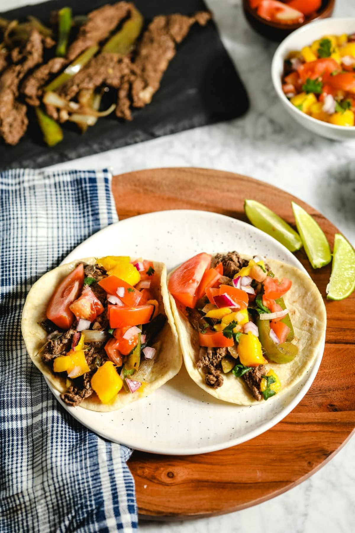 beef fajitas with mango salsa on plate