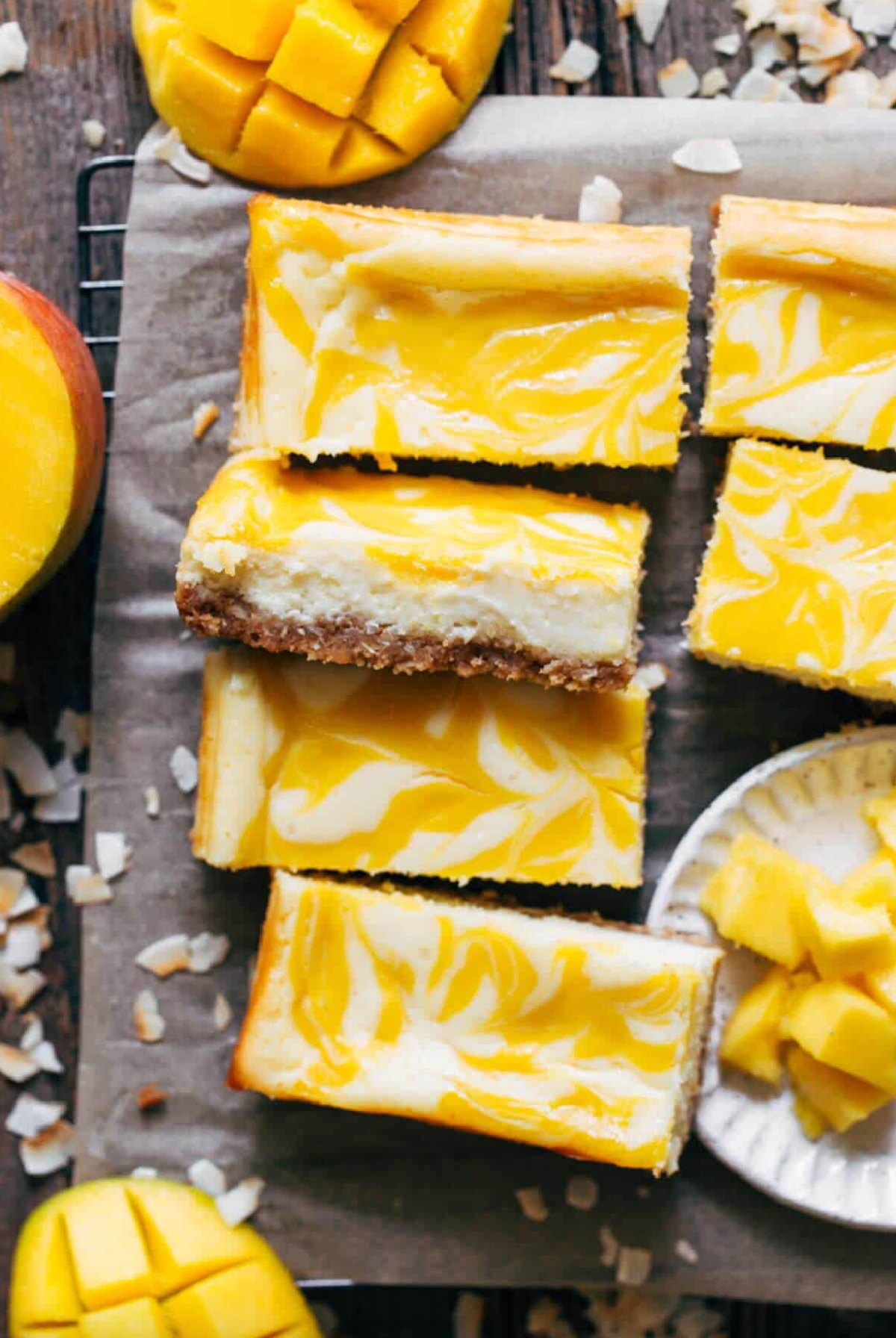 several coconut mango cheesecake bars