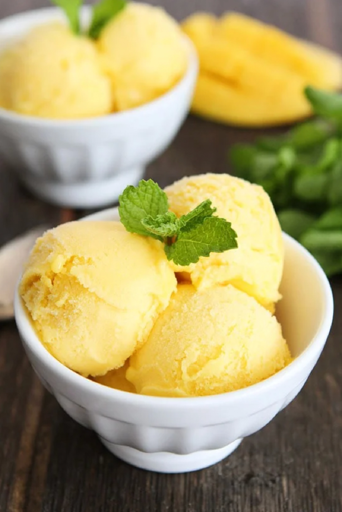 two bowls with scoops of pineapple mango sorbet