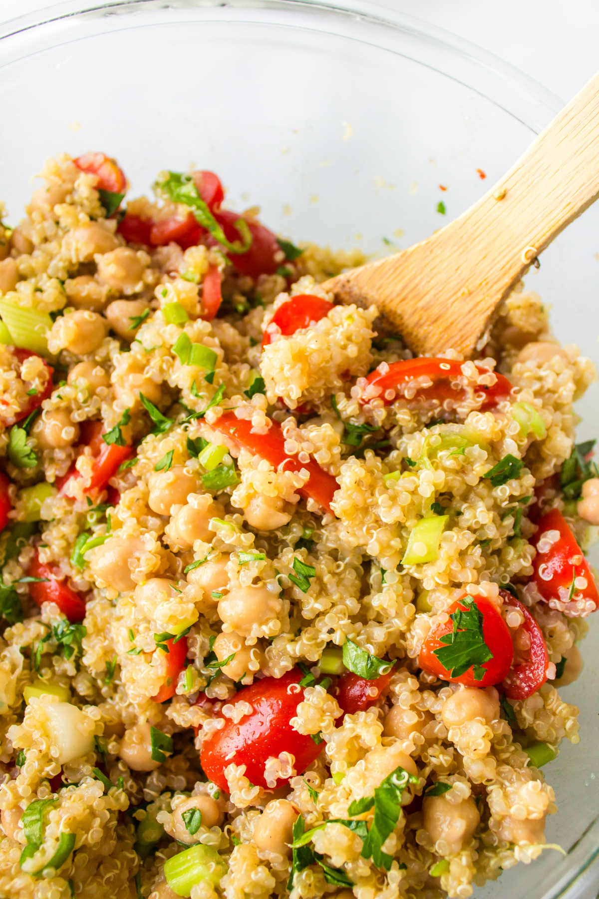 wooden spoon in bowl of easy quinoa salad