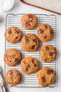 dark chocolate chunk cookies on a baking rack