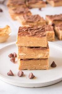 three pieces of peanut butter fudge on plate stacked