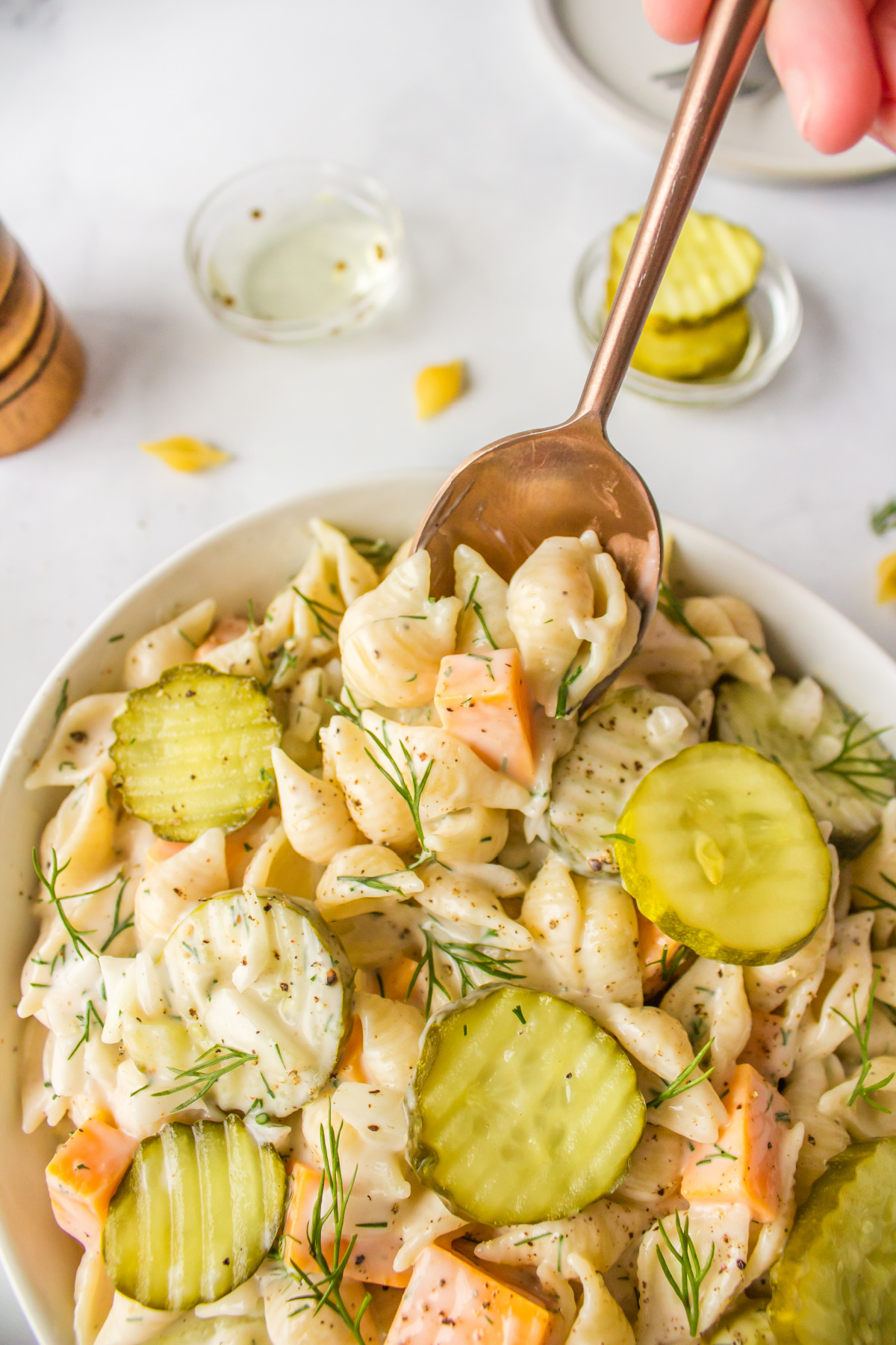 spoon in bowl of dill pickle pasta salad