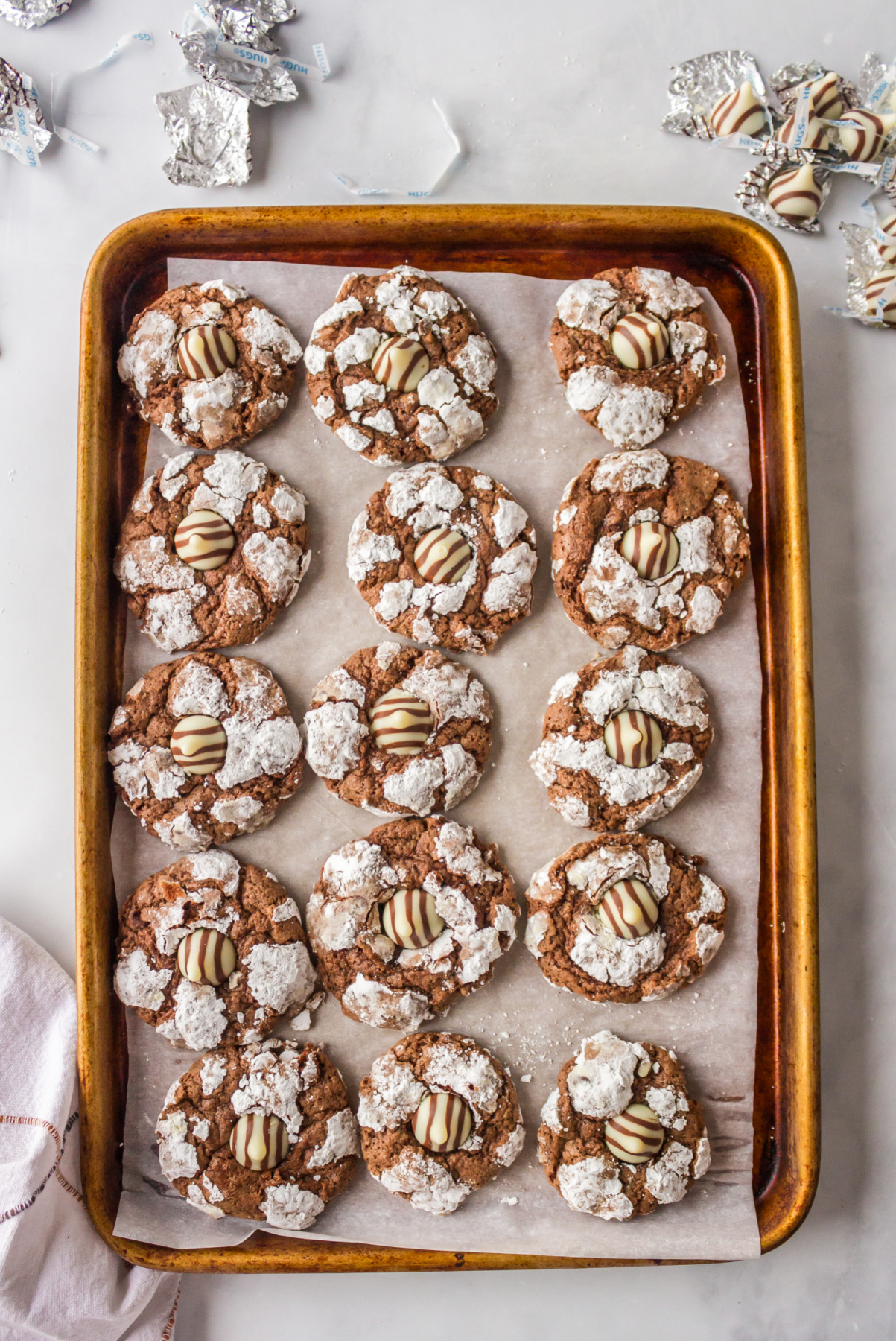 baking sheet of chocolate kiss crinkle cookies