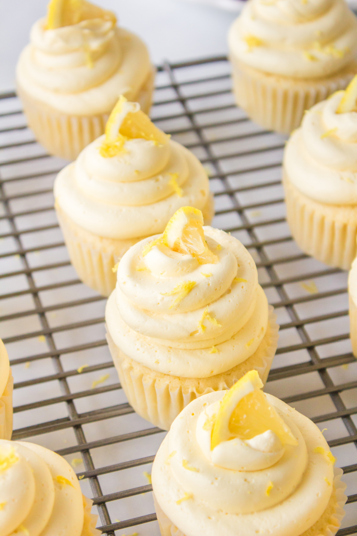 frosted lemon cupcakes on a cooling rack