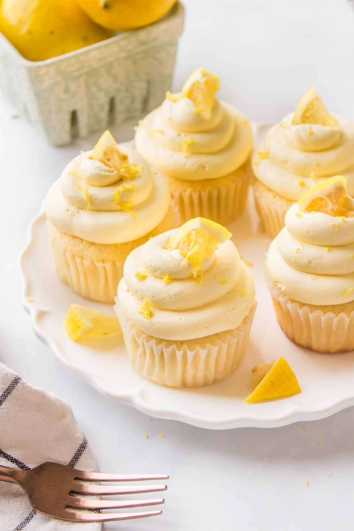 lemon cupcakes displayed on a white platter