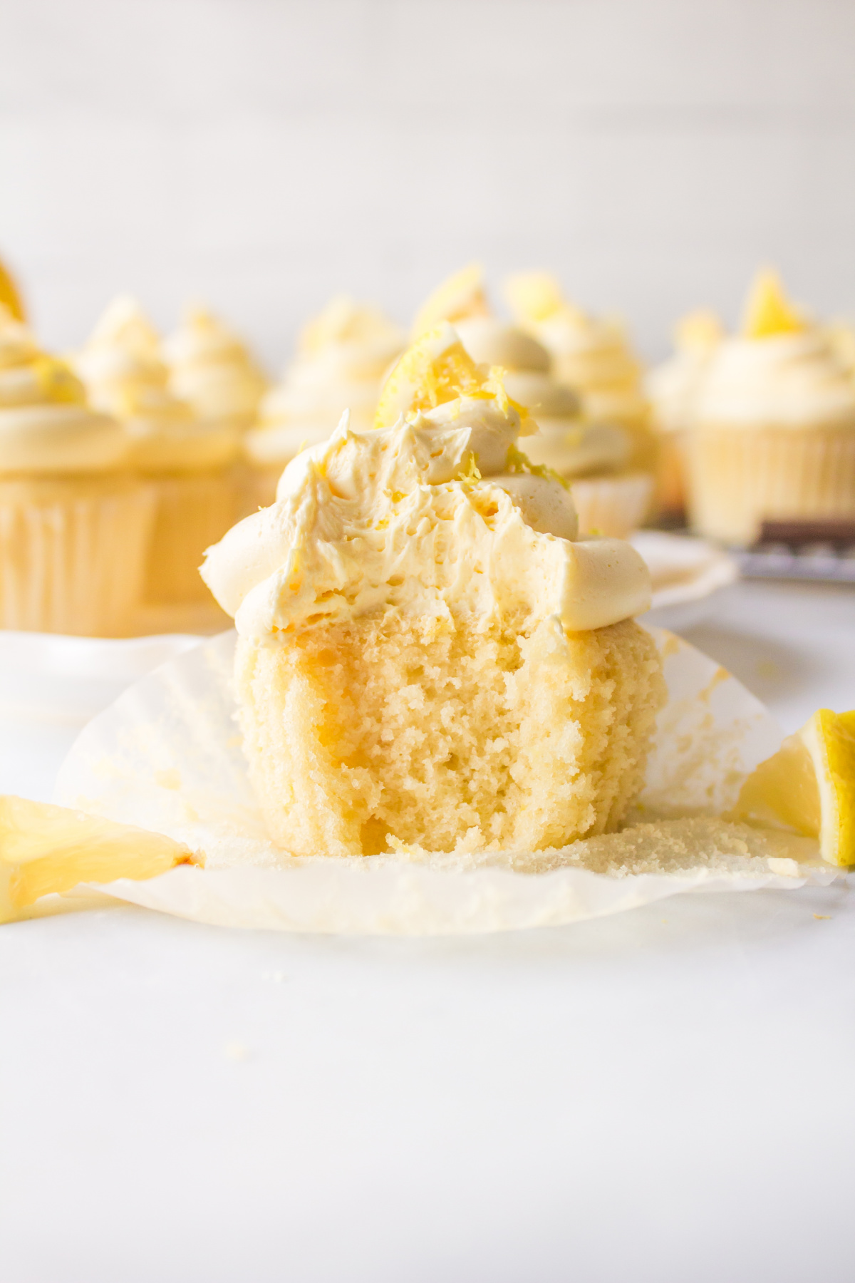 bite out of frosted lemon cupcake