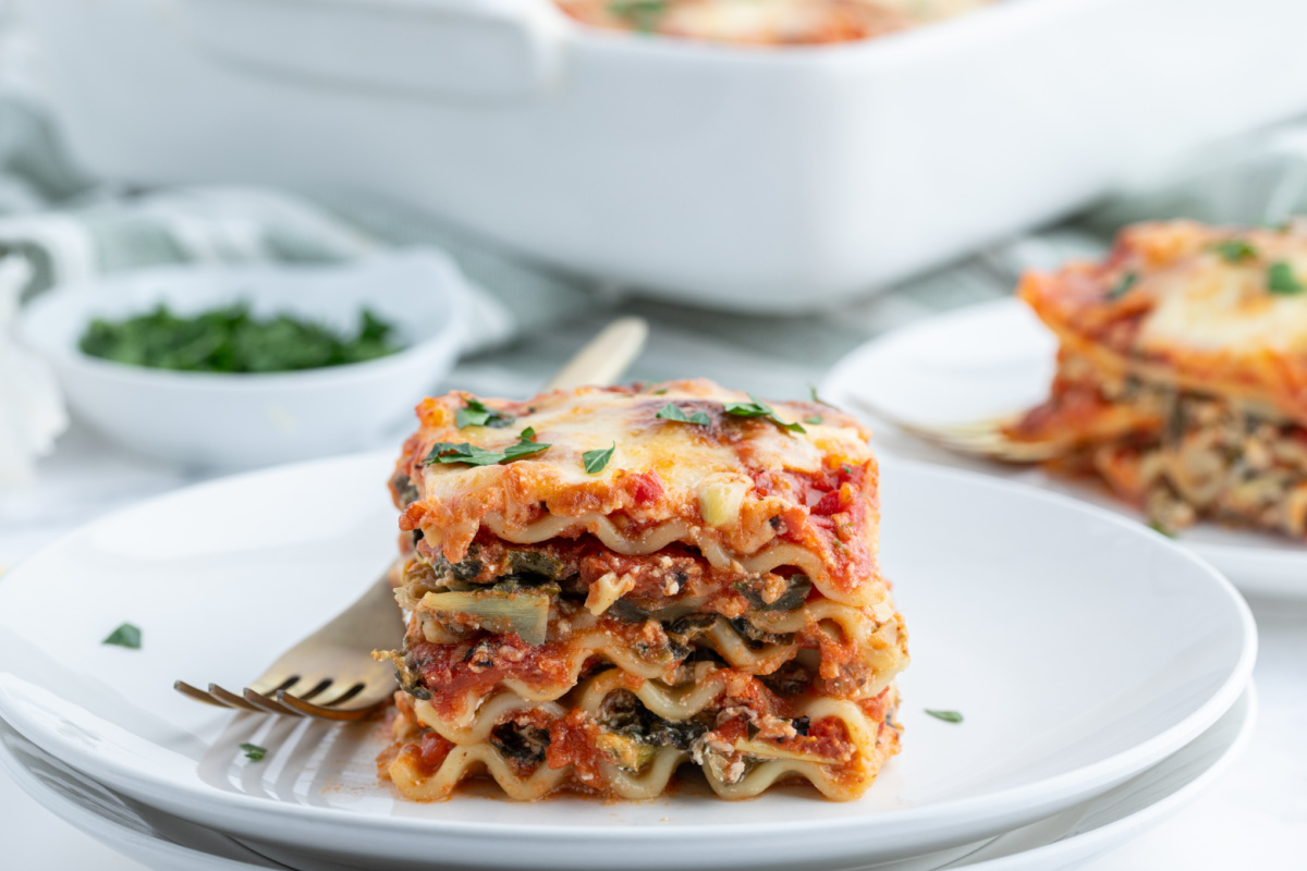 slice of spinach artichoke lasagna on plate